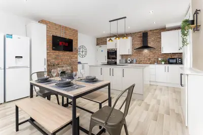 a kitchen and dining room with a table and chairs at Host Liverpool - The Wavertree Rooms in Liverpool
