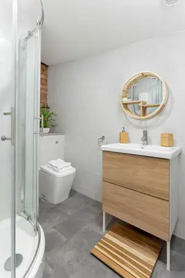 a bathroom with a sink and a toilet and a mirror at Host Liverpool - The Wavertree Rooms in Liverpool