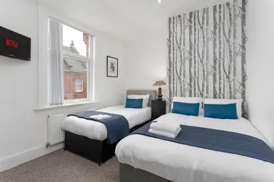 a bedroom with two beds and a window at Host Liverpool - The Wavertree Rooms in Liverpool