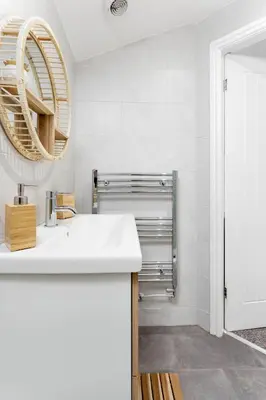 a bathroom with a white sink and a mirror at Host Liverpool - The Wavertree Rooms in Liverpool