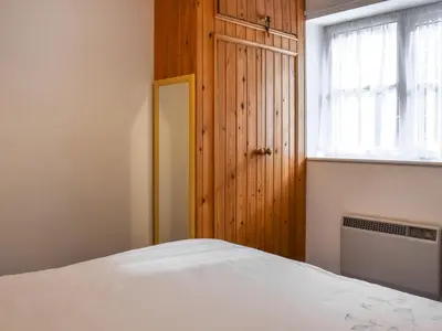 a bedroom with a white bed and a window at Mount Cottage in Wennington