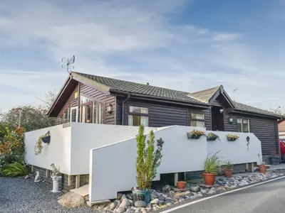 a house with a white fence in front of it at Serenity in Millom