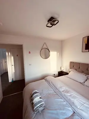 a bedroom with a large white bed with a lamp at Newhaven House in Liverpool