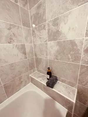 a bathroom with a bath tub with a soap dispenser at Newhaven House in Liverpool