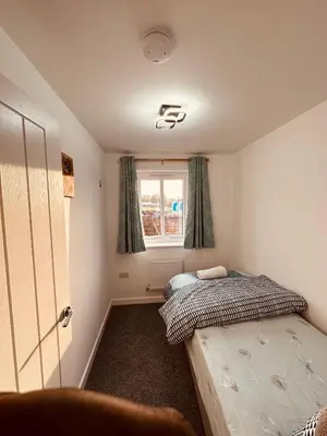 a bedroom with two twin beds and a window at Newhaven House in Liverpool