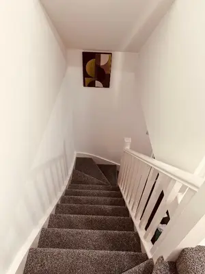 a staircase in a home with white walls and a stair case at Newhaven House in Liverpool