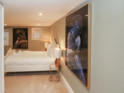 a bedroom with a bed and a painting on the wall at Lord William in Preston