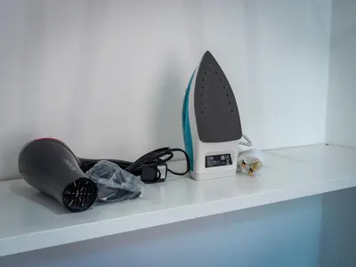 a iron sitting on top of a shelf at Preston Serviced Apartment - Estatevision in Preston
