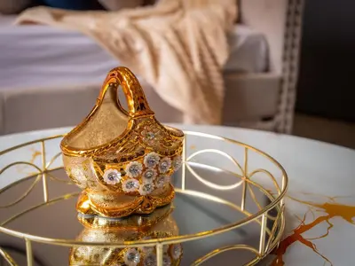 a gold vase sitting on top of a glass table at Preston Serviced Apartment - Estatevision in Preston