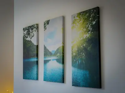 a group of four paintings hanging on a wall at Preston Serviced Apartment - Estatevision in Preston