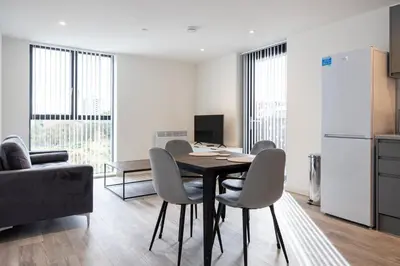 a kitchen and dining room with a table and chairs at GuestReady - Elegant Tranquility in Vauxhall in Liverpool