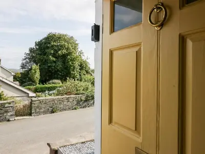 an open door with a view of a street at Penny Bridge House in Ulverston