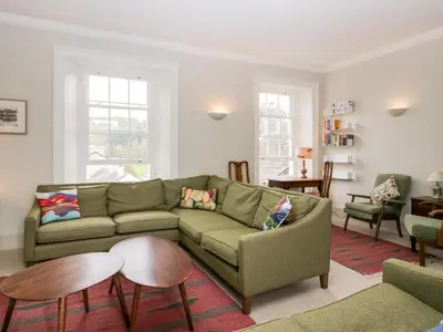 a living room with a couch and a table at Penny Bridge House in Ulverston