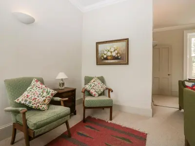 a living room with two chairs and a table at Penny Bridge House in Ulverston
