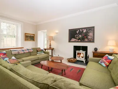 a living room with two couches and a fireplace at Penny Bridge House in Ulverston