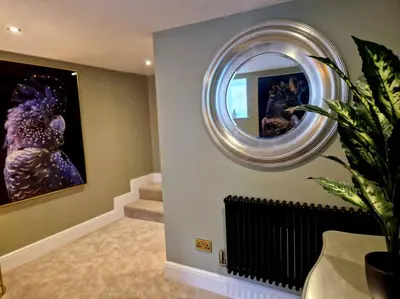 a hallway with a round mirror and a staircase at Hamilton - Lord William in Scorton