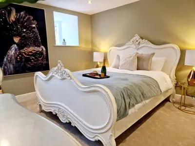a bedroom with a white bed with a table on it at Hamilton - Lord William in Scorton