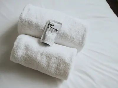 a pile of towels sitting on top of a bed at Modern and Cozy Kirkby Retreat Parking Sleeps 5 - Pass the Keys in Knowsley