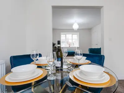 a dining room with a glass table with wine glasses at Modern and Cozy Kirkby Retreat Parking Sleeps 5 - Pass the Keys in Knowsley
