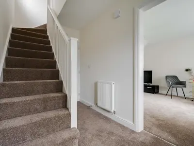 a staircase in a home with a stair case at Modern and Cozy Kirkby Retreat Parking Sleeps 5 - Pass the Keys in Knowsley