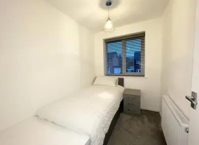 a small bedroom with two beds and a window at Entire house - Peaceful 3 bedroom home in Rishton