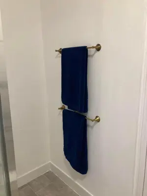 a bathroom with two blue towels hanging on a wall at AGAPI APARTMENT - SEA VIEW SLEEPS TEN in Blackpool