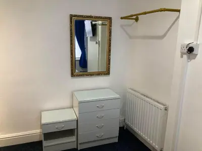 a dressing room with a mirror and a dresser at AGAPI APARTMENT - SEA VIEW SLEEPS TEN in Blackpool
