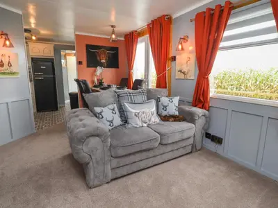 a living room with a couch and a window at Old Bell Farm in Preston