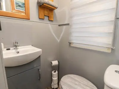 a small bathroom with a sink and a toilet at Old Bell Farm in Preston