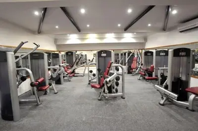 a gym with rows of treadmills and machines at Cliffs Hotel in Blackpool