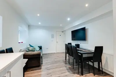 a living room with a table and chairs and a couch at Duke Street Apartment Hotel Liverpool City Centre in Liverpool