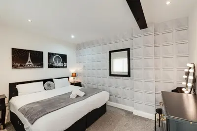 a bedroom with a king sized bed and a mirror at Duke Street Apartment Hotel Liverpool City Centre in Liverpool