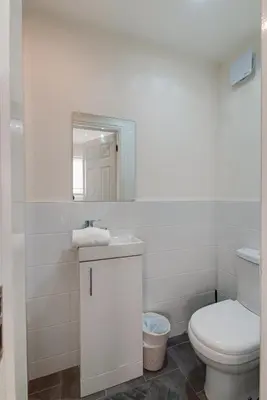 a white bathroom with a toilet and a mirror at Duke Street Apartment Hotel Liverpool City Centre in Liverpool