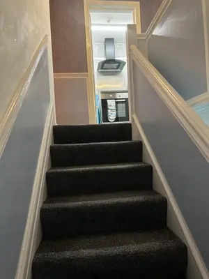 a staircase in a house with a stair case at Quirky Attic Blackpool in Blackpool