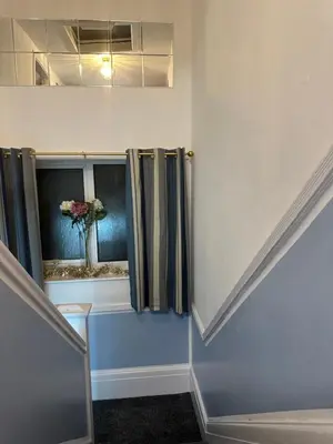 a room with a vase of flowers in a window at Quirky Attic Blackpool in Blackpool