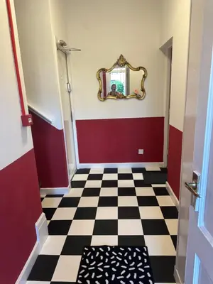 a hallway with a mirror and a checkered floor at Quirky Attic Blackpool in Blackpool