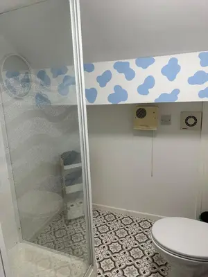 a bathroom with a shower with a toilet at Quirky Attic Blackpool in Blackpool