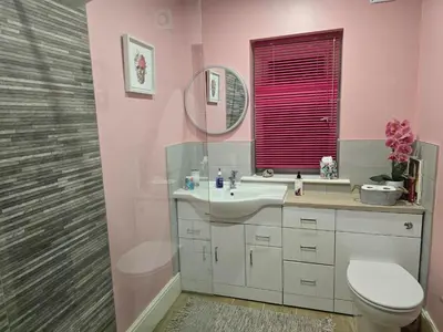 a bathroom with a sink and a toilet and a mirror at Windmill House LYTHAM in Lytham St Annes