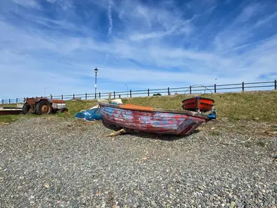a boat sitting on the ground on a beach at Windmill House LYTHAM in Lytham St Annes
