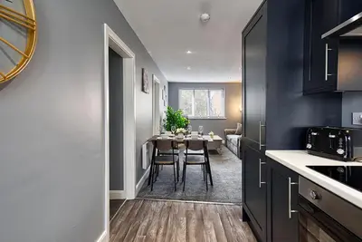 a kitchen with a table and a dining room at Stylish 2 Bed Apartment with Free Parking in Preston