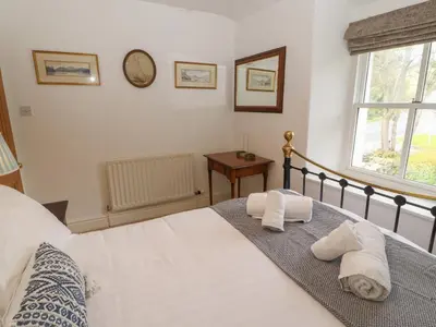 a bedroom with a bed with towels on it at 3 Tower View in Grange Over Sands