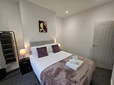 a bedroom with a bed with a towel on it at 16 Newcastle street by Prestige Properties Serviced Accommodation in Barrow in Furness