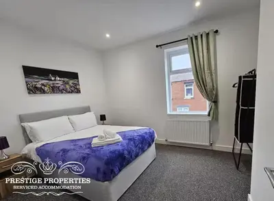 a bedroom with a bed and a window at 16 Newcastle street by Prestige Properties Serviced Accommodation in Barrow in Furness