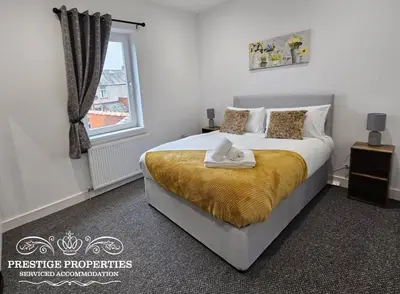 a bedroom with a large bed and a window at 16 Newcastle street by Prestige Properties Serviced Accommodation in Barrow in Furness