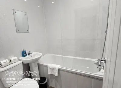 a bathroom with a sink and a tub and a toilet at 16 Newcastle street by Prestige Properties Serviced Accommodation in Barrow in Furness