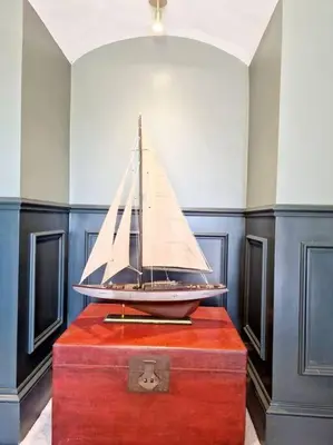 a model boat sitting on top of a red chest at The Hamilton Luxury Let-The Duke in Scorton