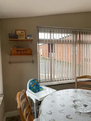 a dining room with a table and a large window at Let It Be in Liverpool