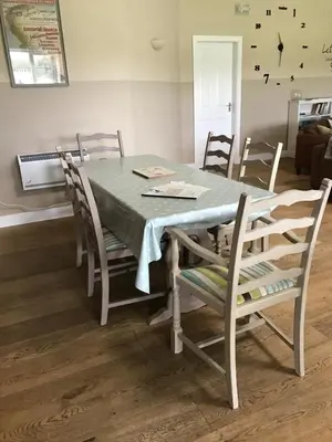 a dining room table with chairs and a blue table cloth at Strawberry Fields in Liverpool