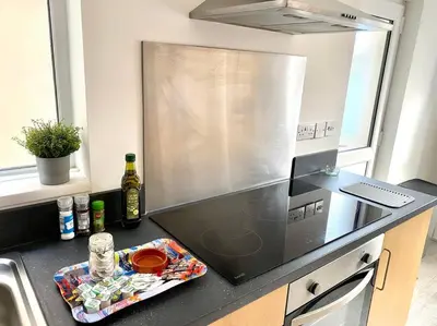 a kitchen with a sink and a stove top oven at Eden Stay 5 Bedroom House in Morecambe