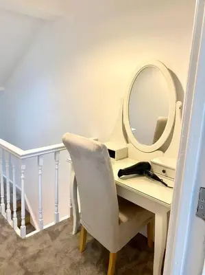 a white desk with a mirror and a chair at Eden Stay 5 Bedroom House in Morecambe